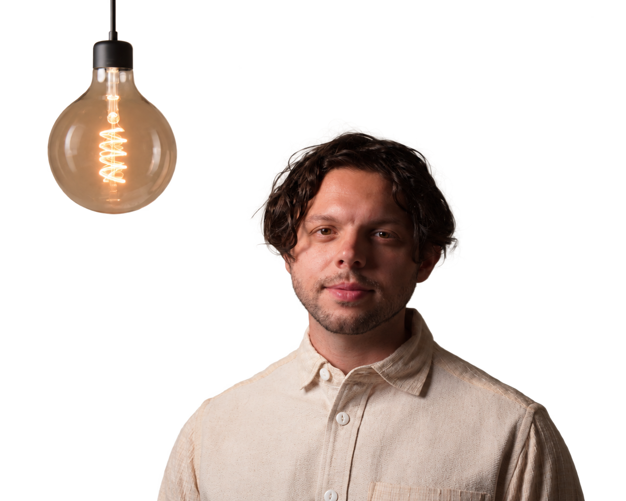 Elijah Munn beside a glowing pendant bulb